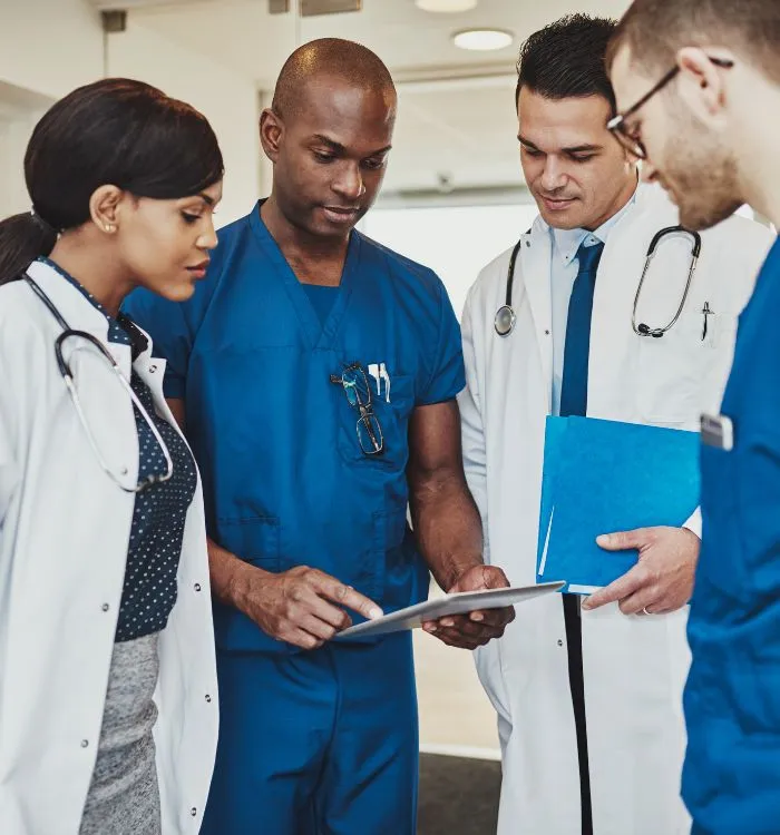 Maniba_RCM_Home_Page_Group_Of_Doctor_Checking_Tablet